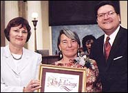 Woman's Justice Center Director Marie De Santis receiving the Woman of the Year award.